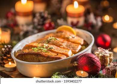 Christmas Dinner From Fish Salmon In Roasting Dish With Festive Decoration Advent Wreath And Burning Candles .