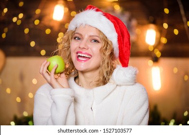 Christmas Dinner Menu. Healthy Girl Care About Dieting. Healthy Food Concept. Health Care. Woman Santa Hat Eat Apple Fruit Christmas Decorations Background. Stay Healthy. Diet And Healthy Nutrition.