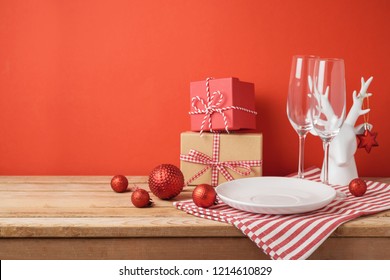 Christmas dinner table setting with empty plate and decorations. Christmas and New Year background - Powered by Shutterstock