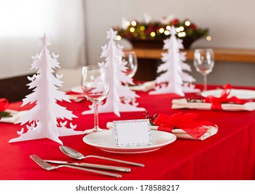 Christmas Dinner Table Setting With Name Card In Red