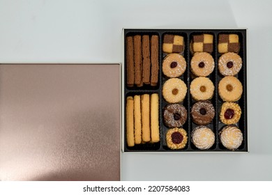 Christmas - Diwali Petitfour Tin Box Biscuits And Cookies Assortment. Holiday Cookie Box. Petitfour Squar Tin Box In A Isolated White Background.  Variety Of Tasty Homemade Cookies Box. 