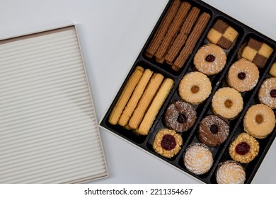 Christmas ,Diwali Petitfour Tin Box Biscuits And Cookies Assortment. Holiday Cookie Box. Petitfour Squar Tin Box In An Isolated White Background.  Variety Of Tasty Homemade Cookies Box