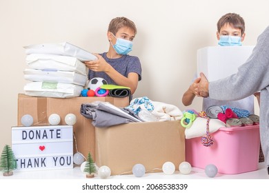 Christmas Donation To Animal Shelter. Volunteer Teenagers Collecting Donations, Preparing Animal Donation Box For Animal Shelters At Christmas Charity