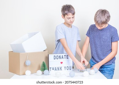 Christmas Donation To Animal Shelter. Volunteer Teenagers Collecting Donations, Preparing Animal Donation Box For Animal Shelters At Christmas Charity