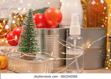 Christmas Donations - Food And Medicines Donations With Bokeh Ligths On Background - Canned Food, Sanitizer With Christmas Decorations. Food Bank, Food Delivery And Charity Concept. Selective Focus