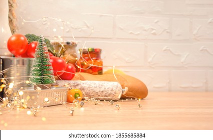 Christmas Donations - Food Donations On Light Background With Copyspace - Pasta, Fresh Vegatables, Canned Food, Baguette, Cooking Oil With Christmas Decorations. Food Bank. Selective Focus