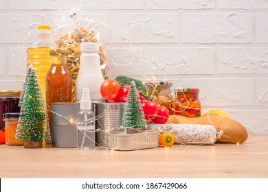 Christmas Donations - Food Donations On Light Background With Copyspace - Pasta, Fresh Vegatables, Canned Food, Baguette, Cooking Oil With Christmas Decorations. Food Bank. Selective Focus