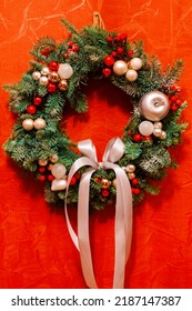 Christmas Door Wreath, A Natural Arrangement Of Flowers, Berries, Fruits And Leaves Fasten On A Ring And Set On A House Entrance Door As Decoration, A Winter Holidays Symbol Of Unending Circle Of Life