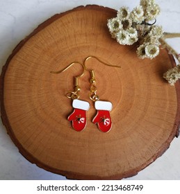 Christmas Earrings On Wood Background 