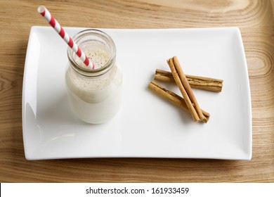 Christmas Egg Nog In A Mini Milk Pot With Cinnamon On A White Plate