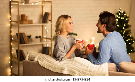 Christmas Eve. Cute Couple In Love Drinking Hot Tea And Enjoying Winter Holidays At Home