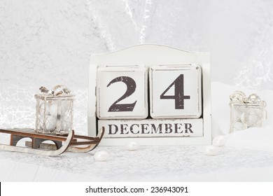 Christmas Eve Date On Calendar. December 24. Christmas Decorations. Gift Box On Sleigh. Sweets.