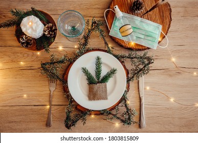  Christmas Eve Holiday Party Decorated Table Set With Disposable Medical Mask And Alcohol Hand Sanitizer Bottle. Coronavirus (Covid 19) Spreading Prevention Concept. Christmas Micro Led Lights Wire.