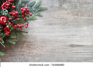 Christmas Evergreen Branches And Berries In Corner Over Rustic Wooden Background