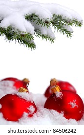 Christmas evergreen spruce tree and red glass balls on snow background