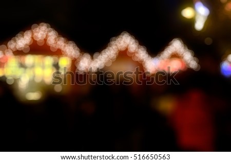 Christmas fair - out-of-focus bokeh background with illuminated seller huts