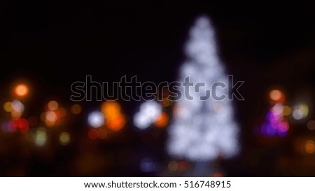 Christmas fair - out-of-focus bokeh background with illuminated snowflakes and christmas tree 