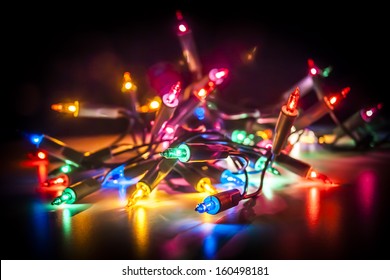 Christmas Fairy Lights Isolated On Reflecting Surface.