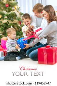 Christmas Family With Kids. Happy Family Opening Gift. Christmas Tree