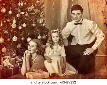 Christmas Family Photo With Mother, Father And Girl In Boxing Day. Black And White Xmas Vintage Image With Child By Home Interior.