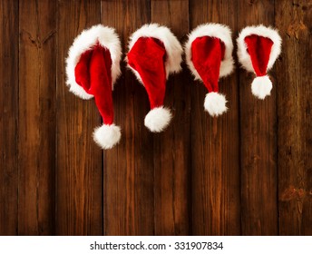 Christmas Family Santa Claus Hats Hanging On Wood Wall, Xmas Kid Hat Hang On Decorated Background