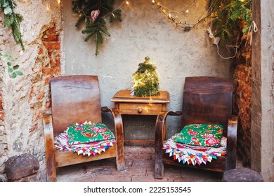 Christmas Family Space In Garden Or Front Porch. Rustic Boho Style Outdoor Decor. Old Rustic Wooden Table And Armchairs. Selective Focus, No Snow