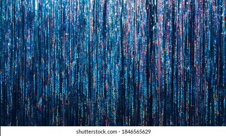 Christmas Festive Background. New Year Celebration. Party Decoration Interior. Colorful Blue Red Shimmer Sparkle Cascade Curtain Copy Space.