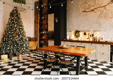 Christmas Festive Interior Of The Kitchen And Dining Room Decorated For The New Year's Holiday In The Loft Style In A Cozy Comfortable House, Selective Focus