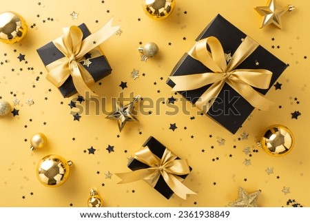 Christmas festivities with gift packages. Overhead shot of black gift boxes featuring golden ribbons, elegant tree ornaments, baubles, star embellishments, confetti on gold backdrop, ideal for advert