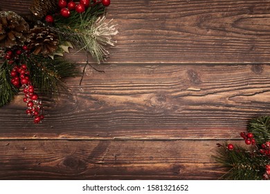 Christmas Fir Tree With Berries Pinecones And Snow On Wooden Background. Flatlay, Top View, Copy Space.