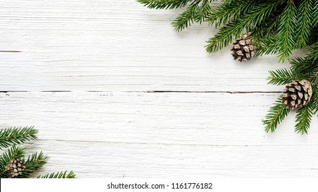 Christmas Fir tree branches and pine cones on white wooden rustic background. - Powered by Shutterstock