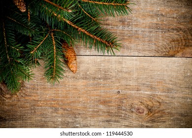 christmas fir tree with pinecones on a wooden board