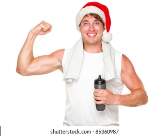 Christmas fitness man showing bicep muscles fit for holidays. Handsome male in his 20s wearing santa hat isolated on white background.