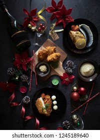 Christmas Flatlay Dinner On Black Table. Dark Food Photography For Christmas. Festive Celebration With Home Cooked Meal. Christmas Food With Wine And Decorations.