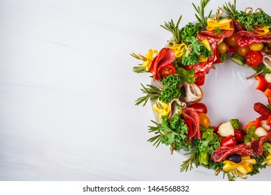 Christmas Food Background. Christmas Wreath Of Holiday Appetizer, White Background, Top View.