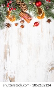 Christmas Food Baking Background. Winter Fir Tree With Spices For Cooking And Christmas Decorations At White Table. Top View With Copy Space.