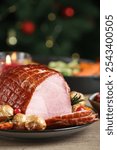 Christmas food. Tasty baked ham served on wooden table, closeup