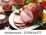 Christmas food. Tasty baked ham served on wooden table, closeup