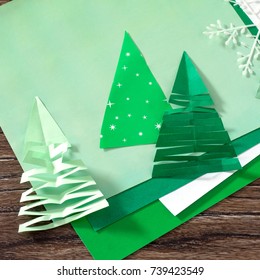 Christmas frame. The child makes paper fir tree. Children's art project, a craft for children. A copy of the pro