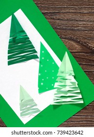 Christmas frame. The child makes paper fir tree. Children's art project, a craft for children. A copy of the pro
