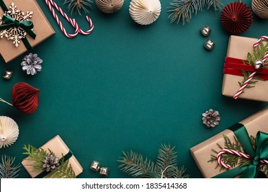 Christmas frame with gift boxes, paper decorations, jingle bells and spruce branches on turquoise background. Holiday background in earth colours. - Powered by Shutterstock