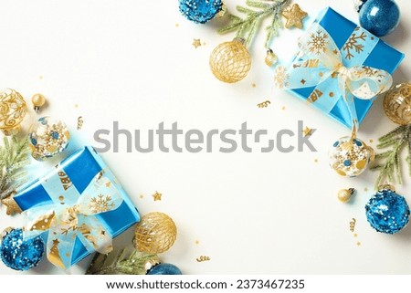 Christmas frame with luxury Christmas decoration, gift boxes, baubles on white table. Flat lay, top view, copy space.