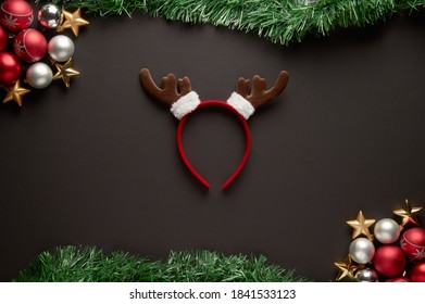 A Christmas Frame With A Ornaments, Garland With Reindeer Antler Headband