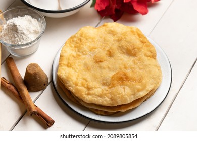 Christmas Fritters With Piloncillo And Cinnamon On A White Background. Traditional Mexican Food