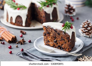 Christmas fruit cake, pudding on white plate. Christmas decoration. Close up.