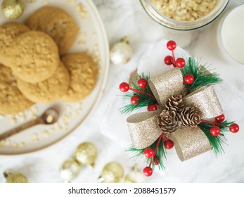 Christmas Gift Box Against Table With Cookies And Glass Of Milk. Christmas Morning Breakfast.