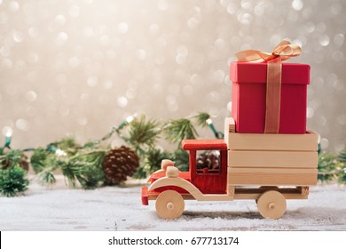 Christmas gift box on toy truck over festive background. Christmas holiday celebration concept - Powered by Shutterstock