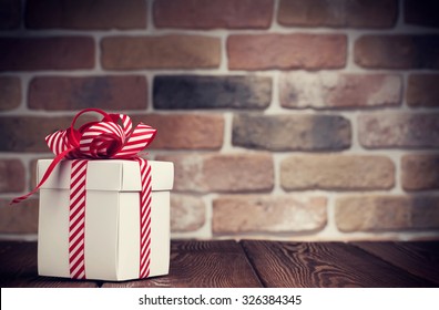 Christmas Gift Box On Wooden Table. View With Copy Space. Toned