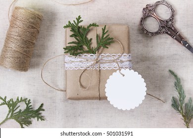 Christmas Gift Box With Round Tag, Mockup Perspective View. Craft Items Set. Wooden Background.