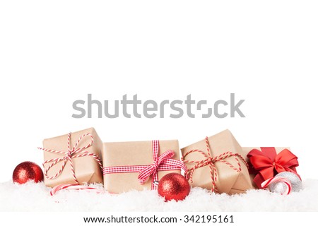 Christmas gift boxes and decor in snow. Isolated on white background